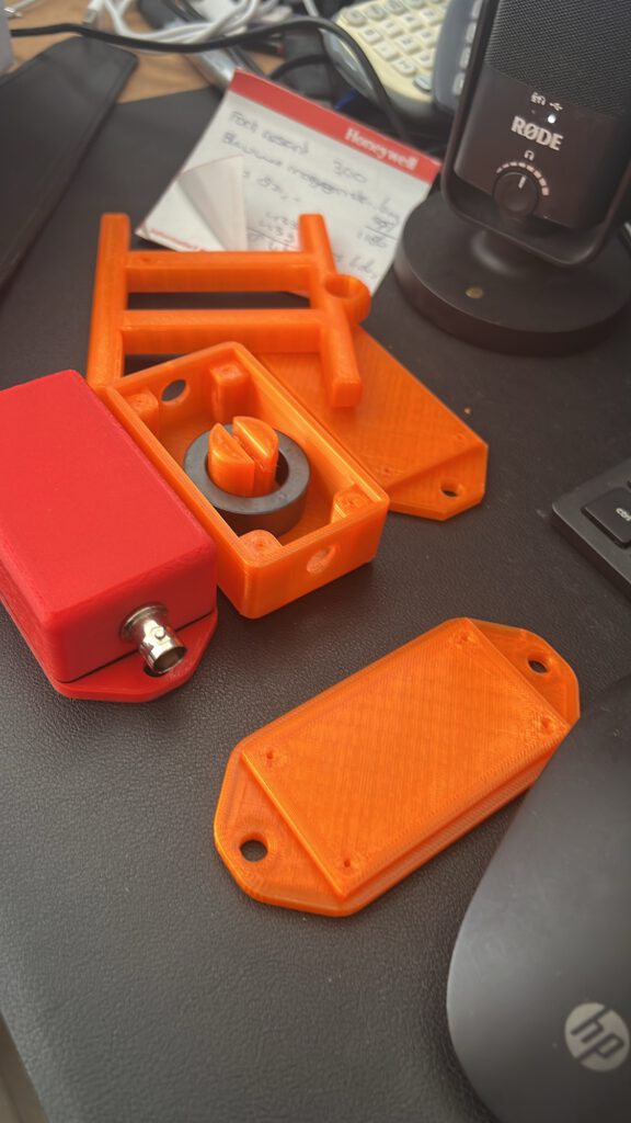 Orange 3D printed antenna parts on the desk