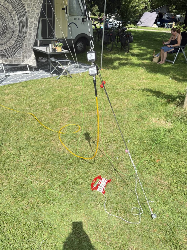 Antenna on a mast on the campsite lawn