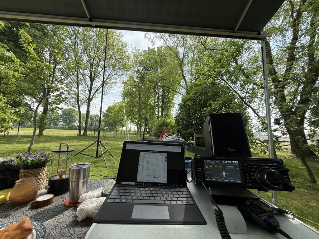Radio setup under the awning of the camper