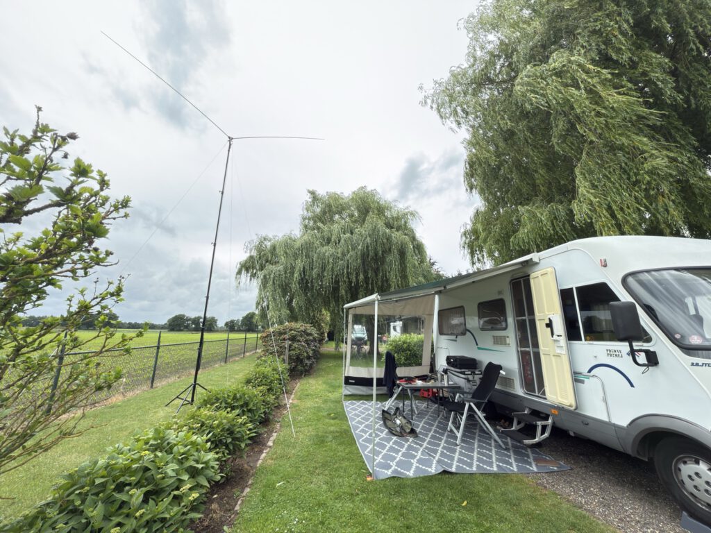 Mobile home with awning and antenna mast